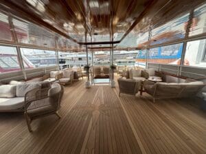 a deck of a boat with chairs and a star on the ceiling